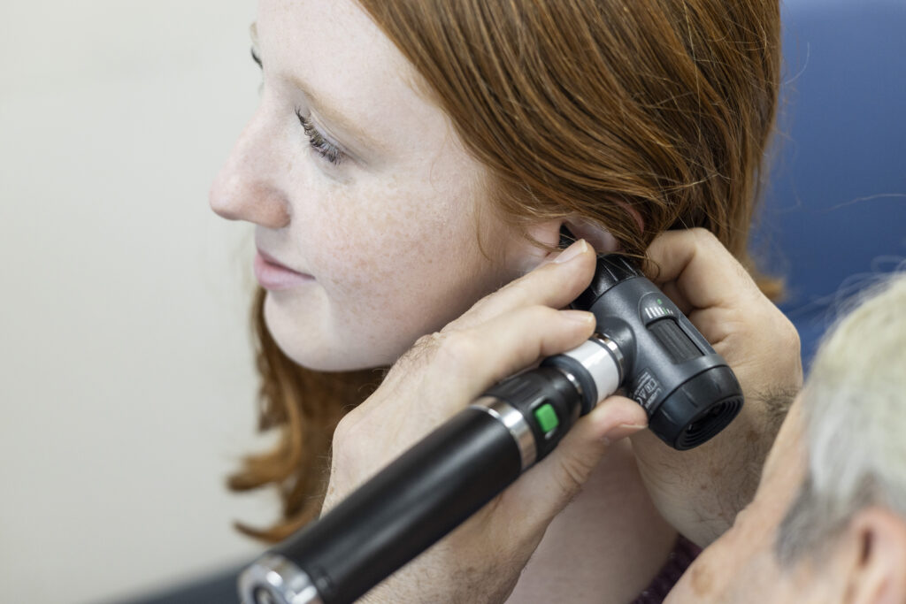 Unravelling Comprehensive Hearing Check-ups in Norwich, UK 4 Unravelling Comprehensive Hearing Check-ups in Norwich, UK woman performing an ear examination with an otosco 2025 04 05 07 20 01 utc